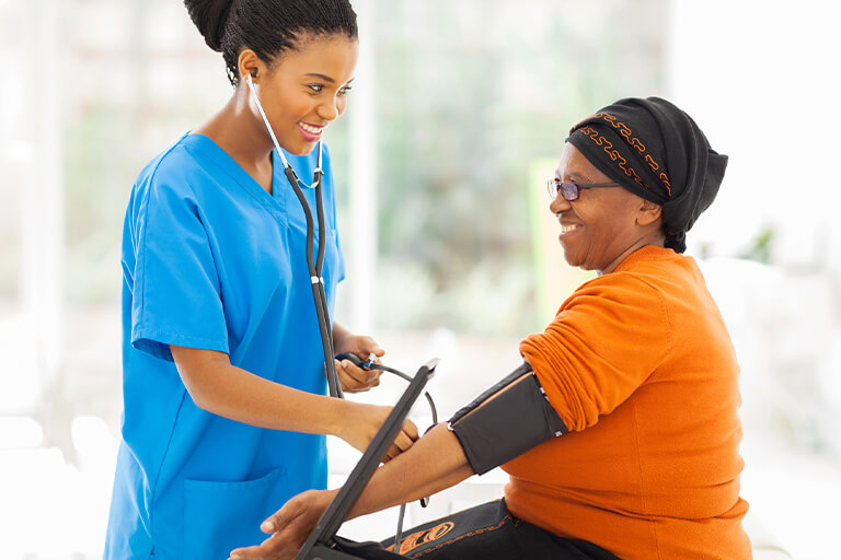nurse practitioner checking patient's blood pressure